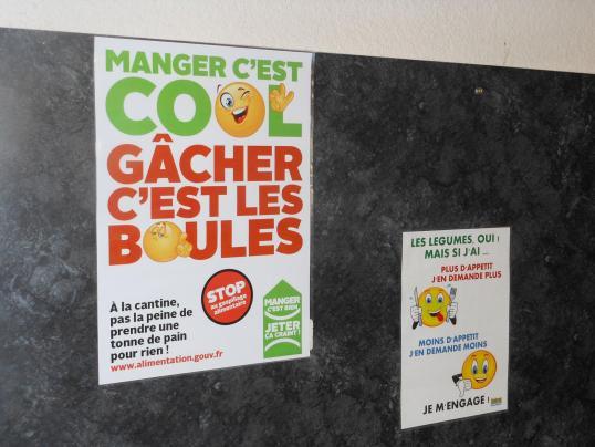 a sign on the wall promoting the lack of waste at the canteen