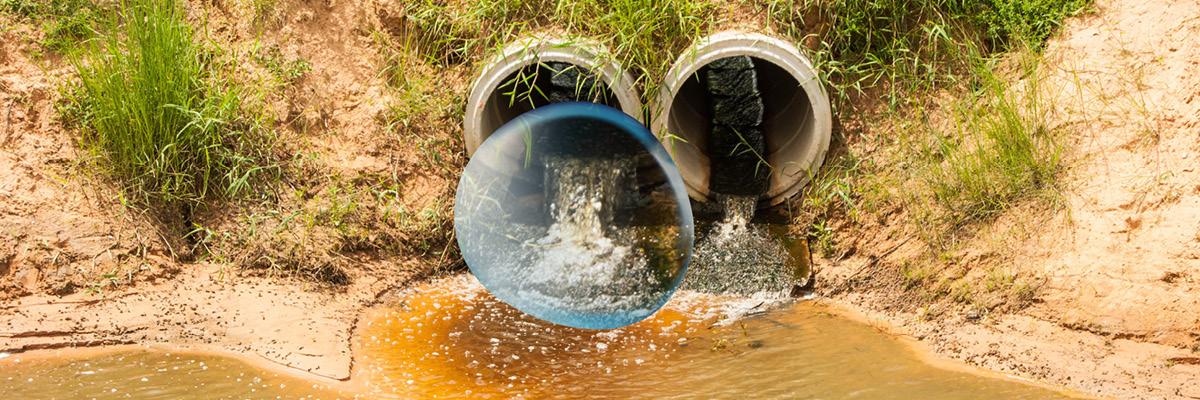 Pipes spilling sewage into river