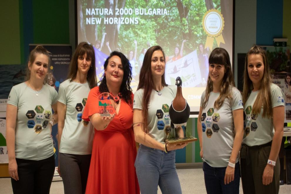 BG: The project team showing off the Natura 2000 Award and presenting a flagship species featured in their communication campaign